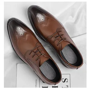 Macro detail of brown brogue shoes featuring vintage gradient wingtip carving and laces