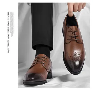 Macro detail of classic wingtip brogue patterns and black gradient toe on brown dress shoe
