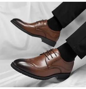 Close-up of brown brogue dress shoes with gradient toe detail and leather carvings