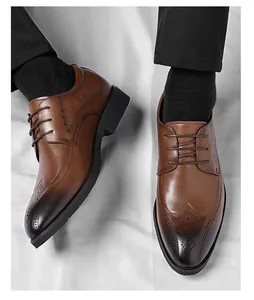 Detail of brown leather brogue shoes with wingtip carving and gradient toe finish