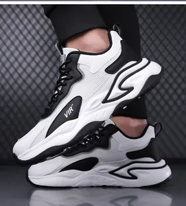 Detail view of black and white chunky sneakers with mesh upper and thick non-slip soles