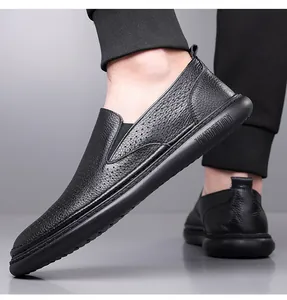 Close-up of black perforated leather loafers with breathable holes and thick rubber soles