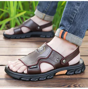 Detail view of brown leather sport sandals for men with dual-wear design on a wooden floor