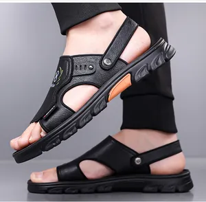Detail of men's black leather sandals with orange accents and adjustable heel strap