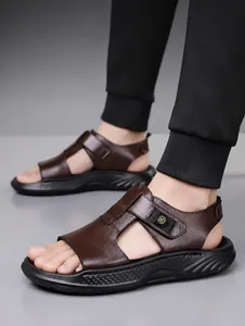 Close-up of brown leather men's sandals with textured surface and velcro straps