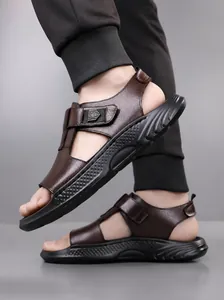 Close-up of litchi texture leather straps and durable stitching on brown outdoor sandals