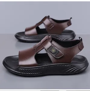 Detail of men's brown leather sandals showing textured finish and adjustable velcro strap