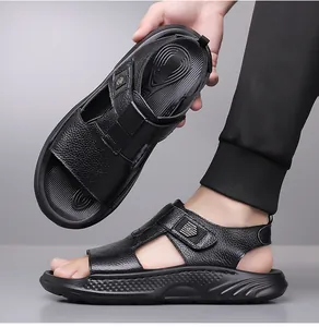 Close-up of black men's sandal showing litchi texture leather and velcro strap detail