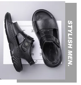 Detail of black leather men's sandal featuring adjustable strap and side metal logo accent