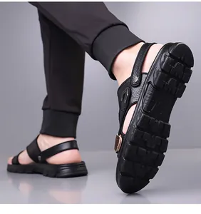 Detail view of anti-slip rubber sole and convertible heel strap on black leather men's sandals