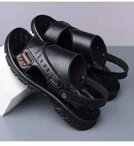 Close-up of black leather men's sandals with metal buckle and rotatable heel strap