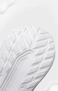 Detailed view of white rubber and EVA outsole with anti-slip traction patterns