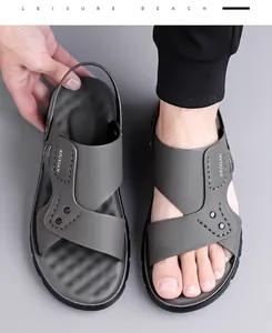 Close-up of grey men's sandals featuring adjustable heel straps and soft rubber soles