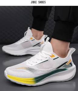 Close-up of white breathable mesh sneakers with yellow and green stripes on foot