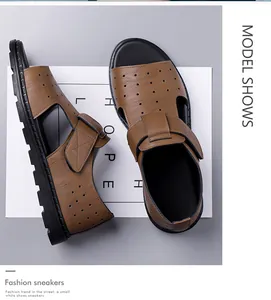 Detailed view of brown leather sandals with breathable holes and black rubber soles