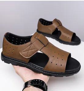 Detail of brown leather sandals with adjustable velcro straps and breathable cutout design
