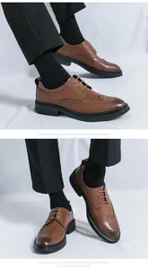Dettaglio di scarpe Brogue marroni con decorazioni a coda di rondine e suola in gomma