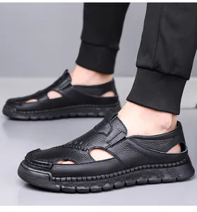 Detailed view of black leather sandals for men featuring breathable hollow-out design