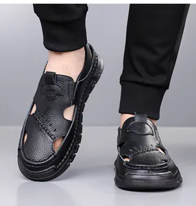 Detail of black leather men's sandals featuring breathable cut-outs and lychee texture