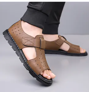 Detailed side view of brown velcro leather sandals with breathable perforated design