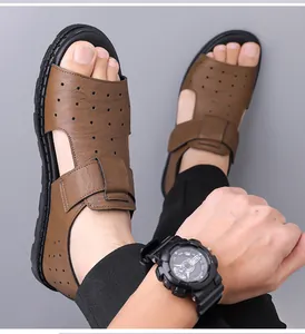 Close-up of brown leather sandals for men featuring breathable hollow-out design and velcro