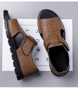 Detail of brown leather sandals with laser-cut holes and durable non-slip rubber soles