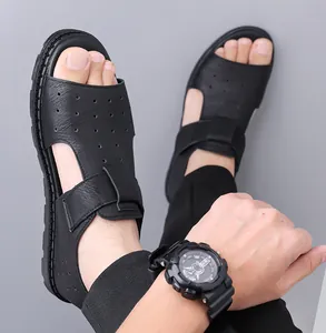 Macro shot of black men's sandals featuring breathable laser-cut holes and Velcro closure
