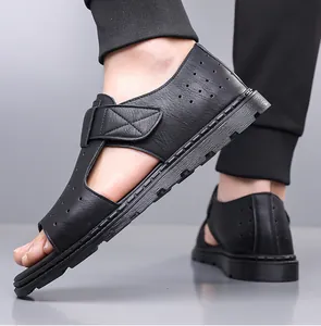 Detail view of black velcro beach sandals with breathable perforated leather and rubber sole