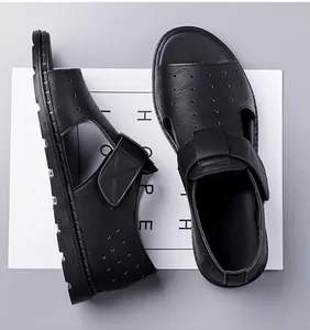Close-up of black leather sandals with velcro straps and breathable perforated texture
