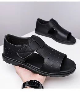 Detail of black men's beach sandals with breathable perforated texture and velcro straps