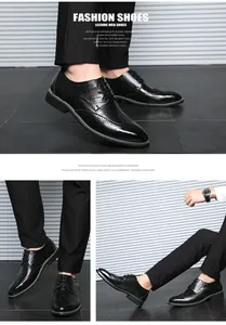 Close-up of black leather brogue shoes with classic wingtip carving and lace-up detail