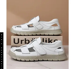 Close-up of white leather men's sandals featuring breathable cut-outs and velcro closure