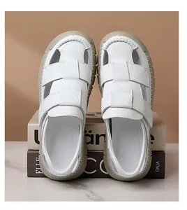 Detail view of white leather woven sandals with thick rubber soles and stitch work