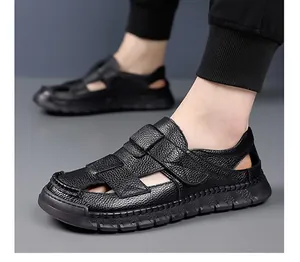 Detail of men's leather closed-toe sandals with velcro strap and litchi texture