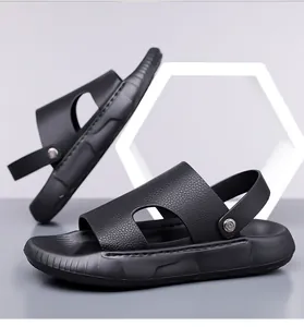 Detail view of black leather-textured men's beach sandals with adjustable heel strap