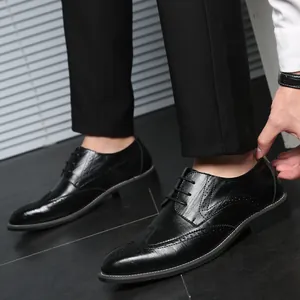 Men's black leather Oxford brogue shoes with classic wingtip design for formal business