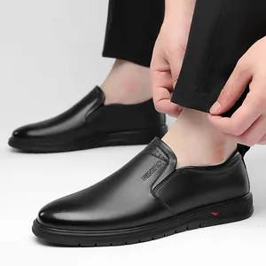 Detailed close-up of a black leather slip-on shoe showing the elastic band and side texture