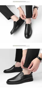 Detailed macro view of black pebbled leather texture and stitching on men's slip-on loafers