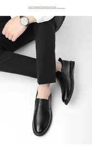 Close-up of black cowhide leather slip-on shoes for men showing polished texture and finish