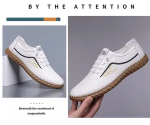 Detail view of white casual leather shoes with gold stripes and flexible rubber sole