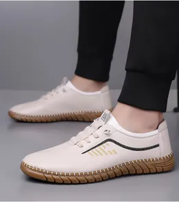 Detail of cream leather loafer showing manual side stitching and textured cowhide finish