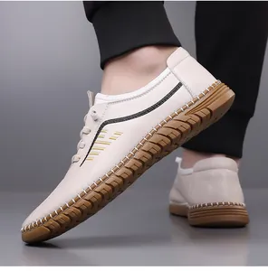 Close-up of men's cream leather casual shoe with non-slip rubber sole and stripe detail
