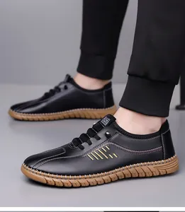 Detail of black leather business casual shoes showing side stripes and brown rubber sole