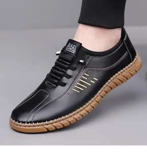 Close-up of men's black leather loafer showing golden embroidery and stitching details