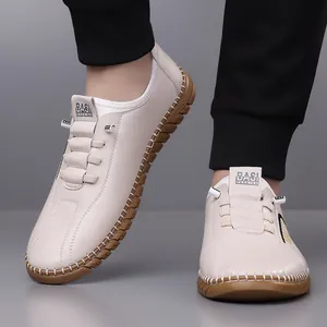 Men's casual slip-on beige leather shoes with hand-stitched detail and gum rubber sole