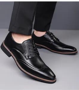 Close-up of black wingtip brogue leather shoes with elegant dress trousers