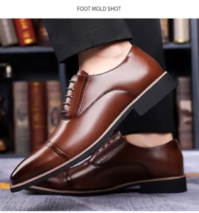Close-up of brown leather Oxford shoes with classic wingtip brogue detailing and waxed laces