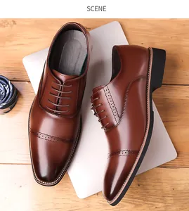 Detailed overhead view of brown brogue leather shoes with intricate wingtip carvings
