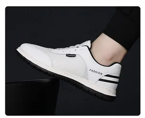 Close-up of men's white mesh sneakers with fashion lettering and black heel stripes