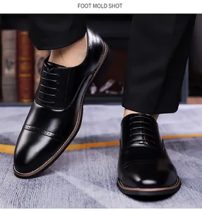 Detail of black brogue dress shoes with cap-toe design and mirror finish leather